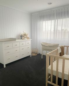 a baby's room with a crib, dresser and bed in the corner