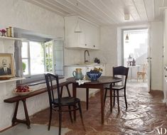 a kitchen with white walls and wooden floors