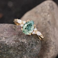 a green ring sitting on top of a rock