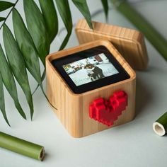 a small wooden box with a red heart on it