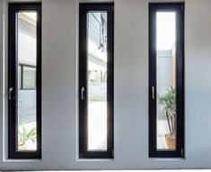 three windows with black frames and glass doors