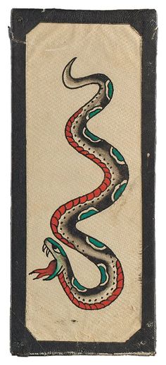 an old book with a snake painted on the front and side of it's cover