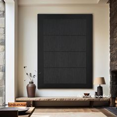 a living room with stone fireplace and large black framed art on the wall above it