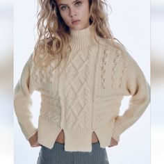 Cable Knit Pompom Sweater With High Color And Front Slits. Ecru Color Winter White Open Knit Sweater, Chic Cream Chunky Knit Sweater, Chic Chunky Knit Cream Sweater, Zara Winter White Sweater For Winter, Off White Textured Knit Winter Sweater, Off-white Textured Knit Winter Sweater, Beige Knitted Outerwear By Zara, Beige Knitted Zara Outerwear, Zara Beige Knitted Outerwear