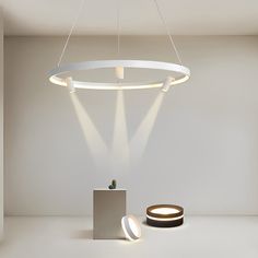 a white room with a round light fixture on the ceiling and a small table in front of it