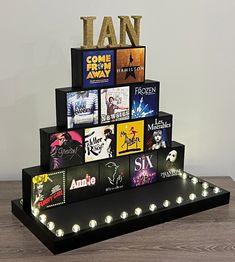 there is a display with many movies on the shelf and lights up in the shape of a pyramid