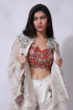 Ivory white floral embroidered jacket. Paired with an inner and embroidered pant.
Components: 3
Pattern: Embroidered
Type Of Work: Chikankari
Neckline: V Neck
Sleeve Type: Flared
Fabric: 25% Silk, 75% Cotton
Color: Ivory,White
Other Details: 
Attached cotton lining
Model Height: 5 ft 7 inches, wearing size M
Closure: Zip
Occasion: Resort - Aza Fashions White Long Sleeve Embroidered Top For Wedding, White Long Sleeve Embroidered Wedding Top, Spring Festive Choli With Intricate Embroidery, White Choli With Floral Embroidery For Festivals, White Floral Embroidered Choli For Festivals, Traditional White Embroidered Top For Festive Occasions, Traditional White Embroidered Festive Top, White Embroidered Festive Top, Traditional White Choli For Spring