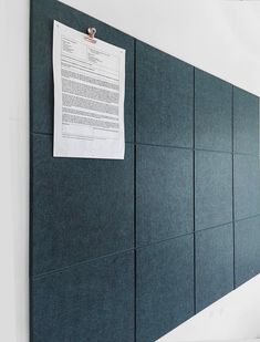 a piece of paper is pinned to the wall