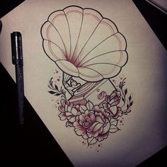 a drawing of a clam shell with flowers on it and a pen next to it