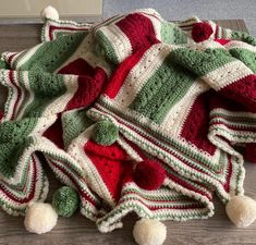 a crocheted blanket is laying on the floor