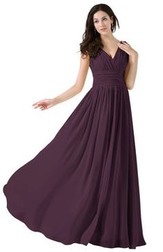 a woman in a long purple dress is posing for the camera with her hand on her hip