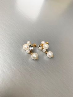 "These dangling earrings are made with the Premium Quality European Crystal and fine cultured freshwater pearls. Available in gold or silver finish. Post back. they measure 2\" in total length. This listing is for the earrings only. - For the matching necklace please take a look here: https://www.etsy.com/listing/1523522188/pearl-and-crystal-necklace-bridal?click_key=81e4ef524819fdd10b78ddecbf71a93c3d54c338%3A1523522188&click_sum=c8a30b1a&ref=shop_home_active_1&frs=1&sts=1 * RETURN POLICY - We d Pearl White Crystal Earrings With Pearl Drop, Pearl White Pearl Drop Earrings With Crystal, White Pearl Drop Earrings In Cubic Zirconia, Delicate Pearl Drop Earrings With Cubic Zirconia, White Crystal Earrings With Pearl Drop For Anniversary, White Bridal Earrings With Pearl Charm And Cubic Zirconia, Pearl White Drop Earrings With Pearl Drop Detail, White Crystal Earrings With Pearl Drop, White Pearl Drop Earrings With Crystal