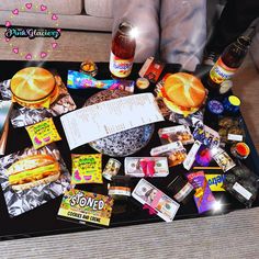 a tray filled with food and condiments on top of a table next to a person's feet