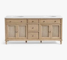 the sideboard with two sinks is made out of wood and has wicker doors