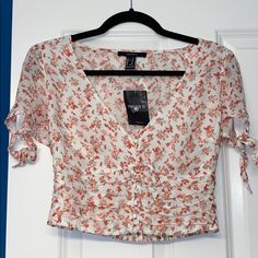 Nwt Floral Crop Top Size Medium. V-Neck, Decorative Buttoned Front And Tie Sleeves. Forever 21 V-neck Summer Crop Top, Forever 21 V-neck Crop Top For Summer, Forever 21 V-neck Crop Top For Spring, Forever 21 V-neck Blouse For Brunch, V-neck Blouse For Brunch From Forever 21, Fitted V-neck Blouse From Forever 21, Fitted V-neck Blouse By Forever 21, Tie Sleeve, Floral Crop Tops