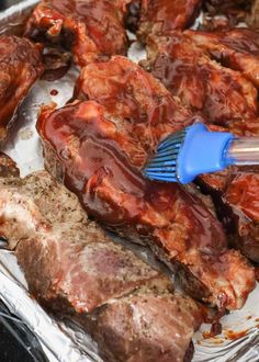 a spatula is being used to stir meat in barbecue sauce on top of steaks