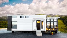 a tiny house on wheels with stairs leading up to it