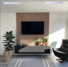 a living room with a large flat screen tv mounted to the side of a wall