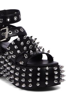 cuz you have a wicked song up your sleeve. These platform sandals have a vegan leather construction, spiked detailing all over, adjustable ankle buckle closures, and back zipper closures.