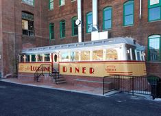 a trolley is parked in front of an old brick building