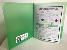 a green folder with writing on it and a sticker that says weekly behavior log