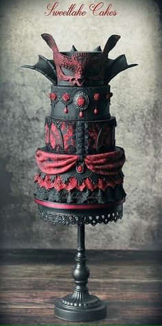 a black and red cake on top of a wooden table with the words sweet like cakes above it