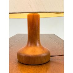 a wooden table with a lamp on it