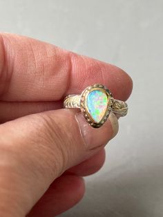 Oh my!! This is gorgeous. A beautiful solid Lighting Ridge Australian opal with blue, pink and green. Set in an 18k gold bezel with a 14k bead detail. The band is a sterling silver floral and leaf design with a 22k gold overlay. The opal measures 10 x 6mm. The band is 1/8" wide and a size 7. Etsy Gold Ring, Gold Overlay, Australian Opal, 22k Gold, Leaf Design, Rings Statement, Oh My, Gold Ring, Pink And Green