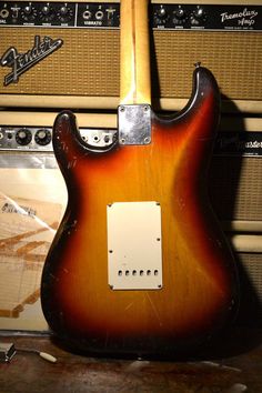 an electric guitar sitting on top of a wooden table