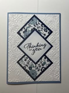 a handmade greeting card with the words thinking on you written in blue and white