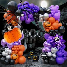 an arch decorated with balloons and decorations for halloween