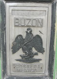 a metal sign with an eagle on it's face and the word buzon written in spanish