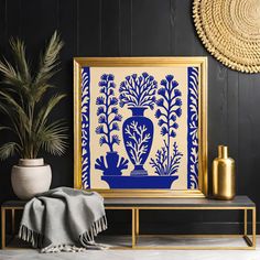 a blue and white vase sitting on top of a table next to a potted plant