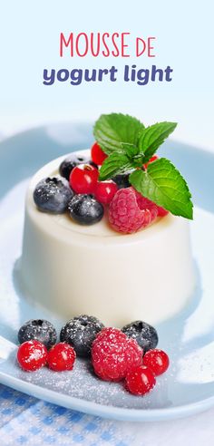 a dessert with berries, raspberries and blueberries on a white plate that says mousse de yogurt light