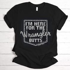 I'm Here for the Wrangler Butts t-shirt. If you know a cowgirl who appreciates a good lookin' cowboy or two, this graphic tee is for her. I mean, who doesn't enjoy a good rodeo now and again? The roping and horseback riding is a sight to see and those bucking bronco riding cowboys are often a sight to behold as well. So why not wear it on your sleeve, or shirt as they say?! Our graphic tees are super soft and super comfy! Unisex sizing. #graphictees Miranda Lambert Outfits, Wrangler Butts, Country Graphic Tees, Bucking Bronco, Teal Shirt, Cute Country Outfits, Rodeo Shirts, Cute Shirt Designs, Cricut Designs