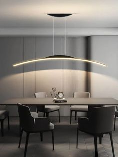 a modern dining table with chairs and a clock on the wall above it, in front of a circular light fixture