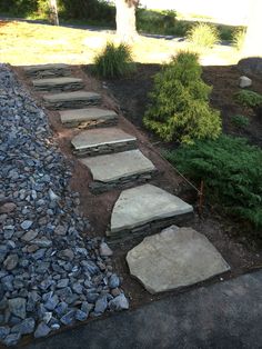 stone steps lead up to the grass and trees