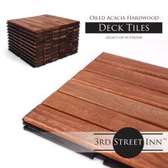 the wooden deck tiles are stacked on top of each other and have black border around them