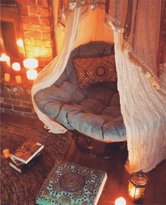 a bed with a canopy over it and some candles on the floor next to it