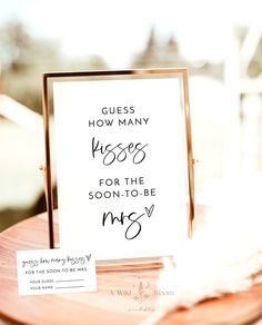 a sign that says guess how many kisses for the soon - to - be mrs