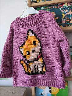 a purple sweater with an image of a cat on it