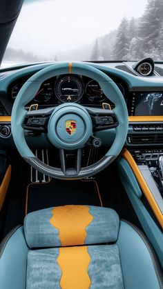 the interior of a sports car with blue and yellow leather