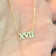 "This little classic Roman Numerals cut-out is composed of 14K solid gold and beautifully complemented by a durable 14K solid gold adjustable chain. This design is also available to be purchased as a charm alone without the chain. ♦ Dimensions: approximately 4mm (h) x 5mm to 9mm (w), depending on the number desired ♦ Metal Finish: High Shine Polish ♦ This design is available in Rose, White and Yellow 14K Gold ♦ Please note that this item takes about 3 to 5 business days for production, prior to Classic Hallmarked 14k Gold Custom Necklace, Classic 14k White Gold Custom Necklace, Custom Yellow Gold Necklace With Diamond Cut For Anniversary, Custom Yellow Gold Diamond-cut Anniversary Necklace, Minimalist Yellow Gold Custom Necklace For Anniversary, Formal Hallmarked 14k Gold Custom Necklace, Silver Custom Necklace In 14k Gold For Formal Events, 14k Gold Custom Necklace For Anniversary, 14k Gold Tarnish Resistant Necklace For Anniversary