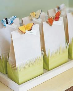 several bags with small butterflies on them sitting on a counter next to each other,