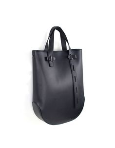 Eraser Tote Bag is made with premium full grain Italian leather, and lined with Micro Fiber. It has an inner zipper pocket, and it featuring an adjustable leather shoulder strap. /Genuine Italian leather/Lightweight/Hidden magnetic closure/Outer Composition:100% Italian leather/Inner Composition: 100% Micro Fiber/Color: Black/Antique Silver Plating Hardware/Size:Width: 28cmHeight: 37.5cmDepth: 7.5cmShoulder Drop: 39.5cm /Weight: 965g Black Tote Bag With Single Handle, Modern Black Anti-theft Bag, Black Leather Lined Tote Bag, Black Soft Leather Shopping Bag, Black Leather Bag With Anti-theft Pocket, Black Bag, Magnetic Closure, Italian Leather, Zipper Pocket