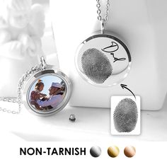 two necklaces with a fingerprint on the front and back, one has a photo in it