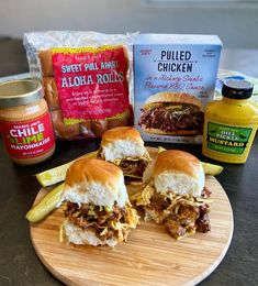 pulled pork sliders on a cutting board with ingredients