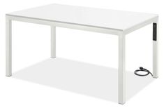 a white table with an electric outlet plugged in to it's side end