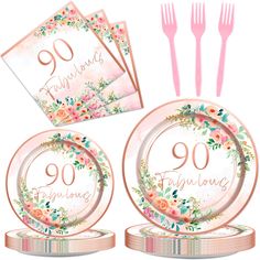 a set of pink plates and forks with floral designs on them, along with napkins that say 90th birthday