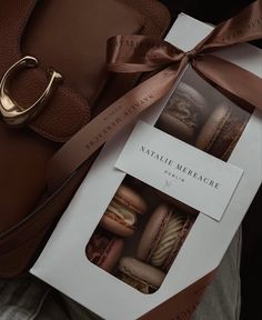 an open box of macaroni and cheese pastries next to a handbag